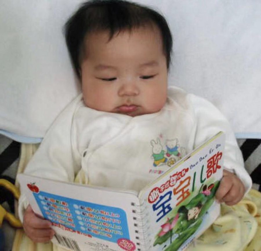 Steven as a baby, reading a Chinese picture book